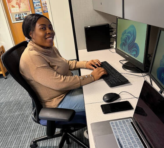 Priscilla Aroboi sitting at desk